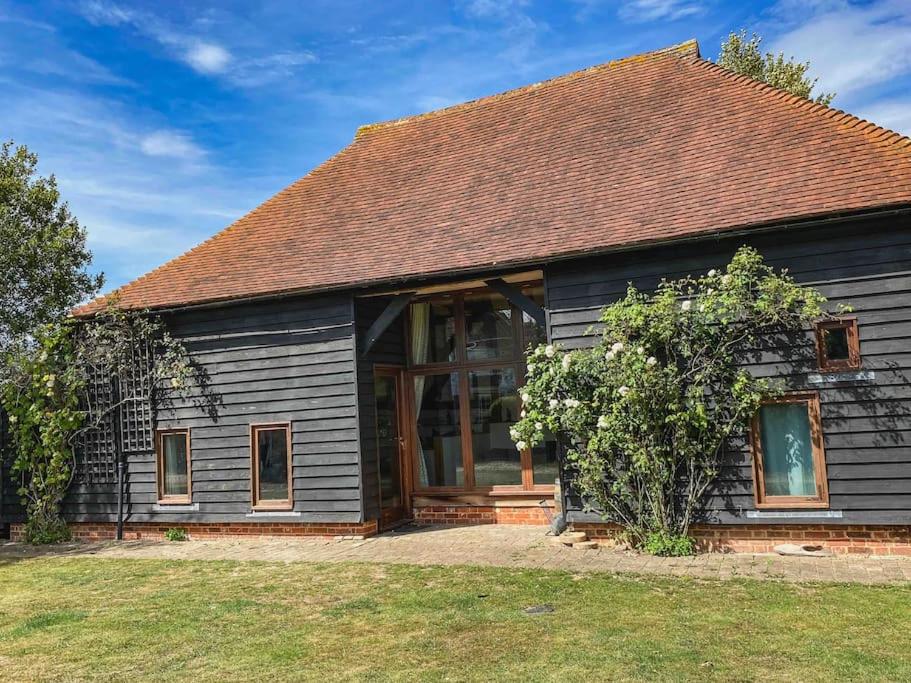 a house with a large window on the side of it at The Hop Barn in Staplehurst