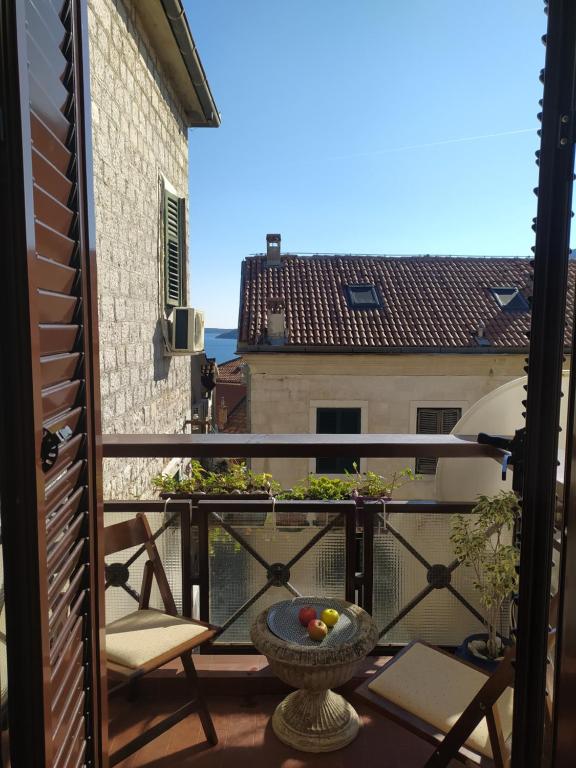 a balcony with a bowl of fruit on a table at City life apartman in Herceg-Novi