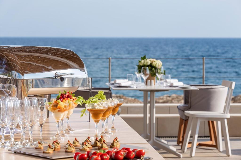 a table with wine glasses and appetizers on a yacht at Horizon Blu Boutique Hotel in Kalamata