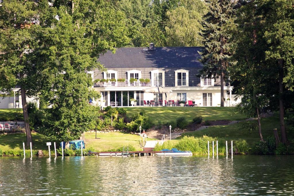 a house on the shore of a body of water at nook x Seepalais Boutique Hotel in Bad Saarow