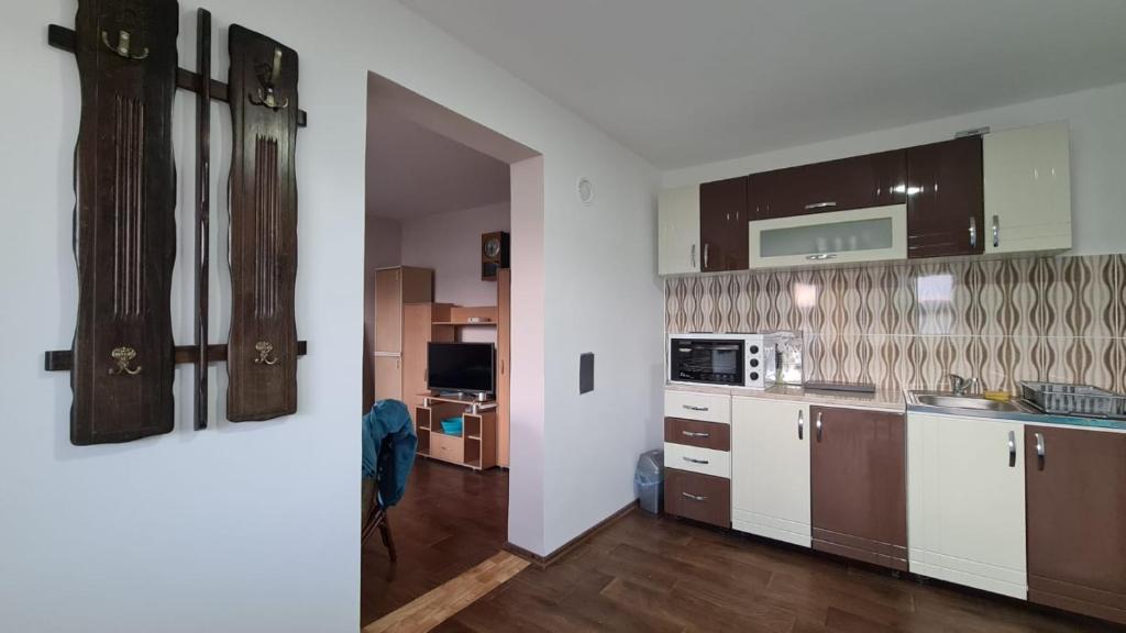a kitchen with brown and white cabinets and wooden floors at Koliba in Pirot