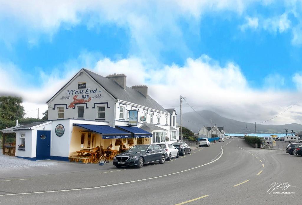 a large white building with cars parked in front of it at Westend Bar & Restaurant in Fenit