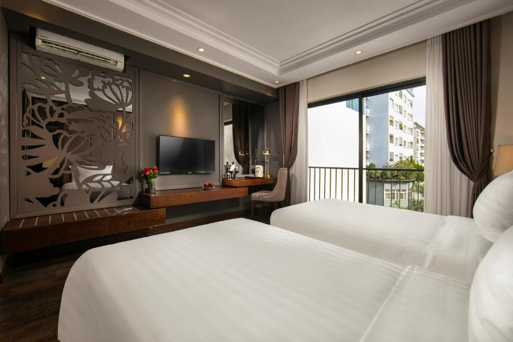 Postel nebo postele na pokoji v ubytování Ping Diamond Hotel Hanoi