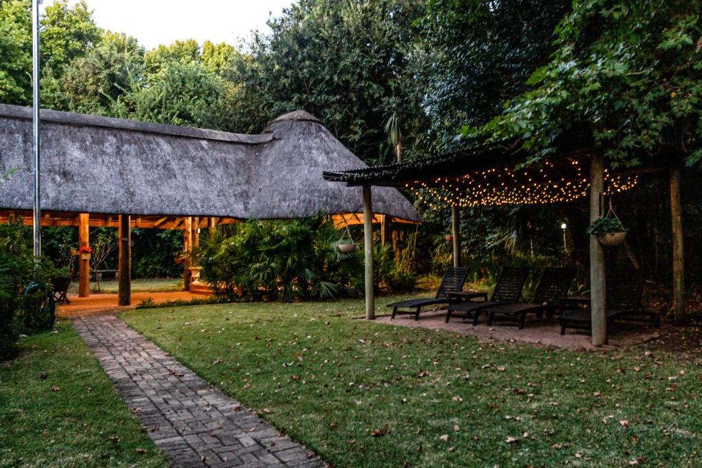 a patio with two benches and a gazebo at Winterton Country Lodge @ Rose Cottage in Winterton