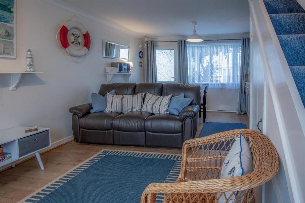 a living room with a couch and a chair at Trewent Park - 2 Bedroom Chalet - Freshwater East in Hodgeston