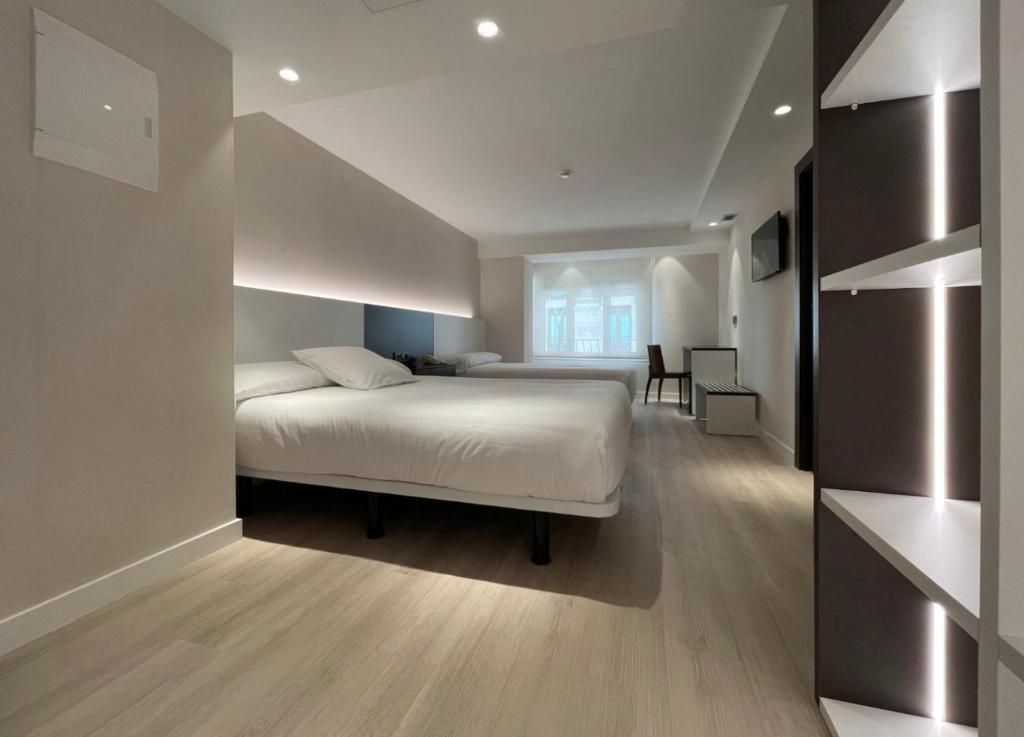 Postel nebo postele na pokoji v ubytování Hotel Remigio