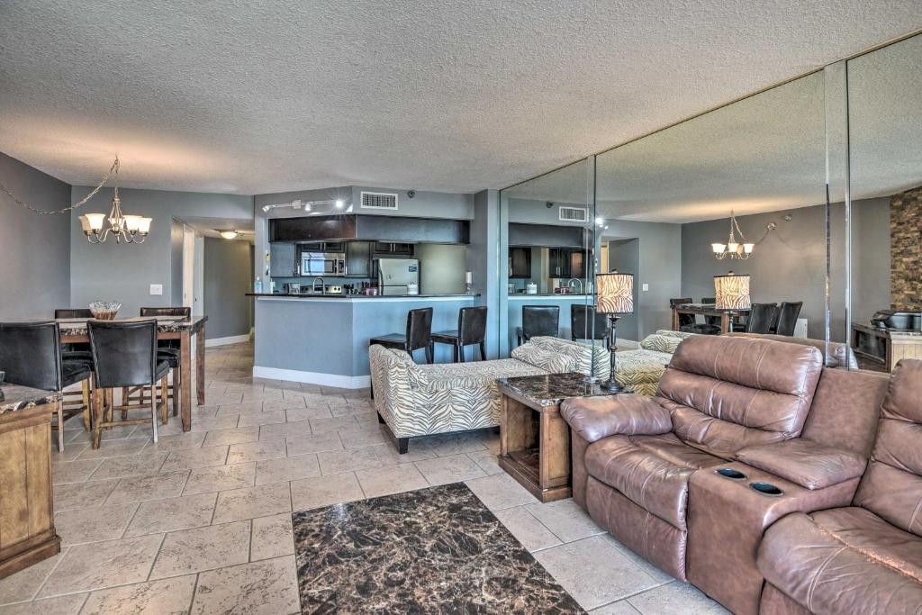 a living room with a couch and a table at Sleek Beachfront Getaway with Community Perks! in Daytona Beach Shores