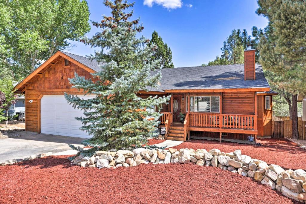 a log home with a tree in front of it at Pet-Friendly Big Bear Cabin about 6 Mi to Ski Resorts! in Sugarloaf