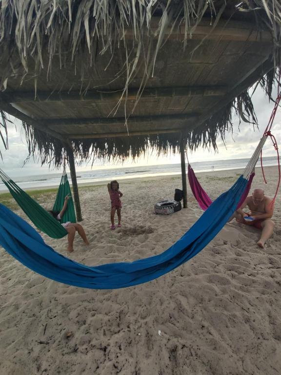 een groep mensen in hangmatten op een strand bij Hotel California in Montañita