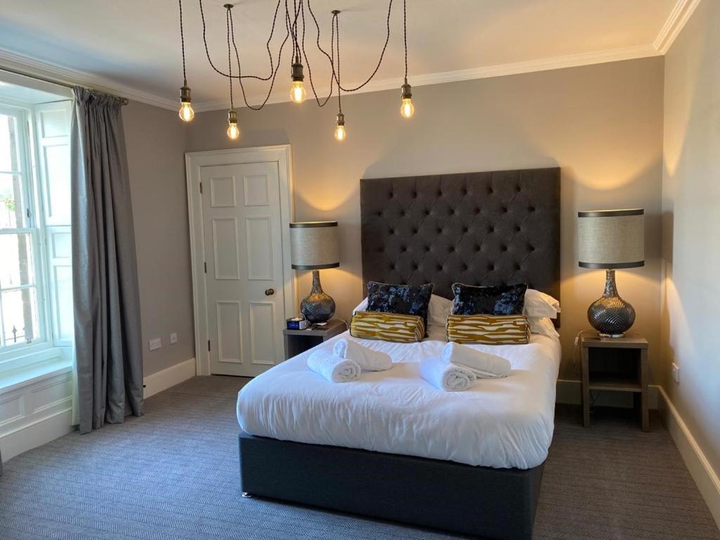 a bedroom with a large bed with two pillows at No. 41 Town House in Inverness