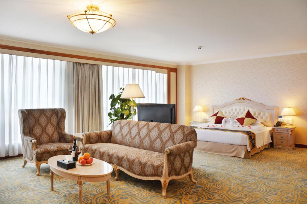a hotel room with a couch and a bed at Beijing Asia Pacific Garden Hotel in Tongzhou