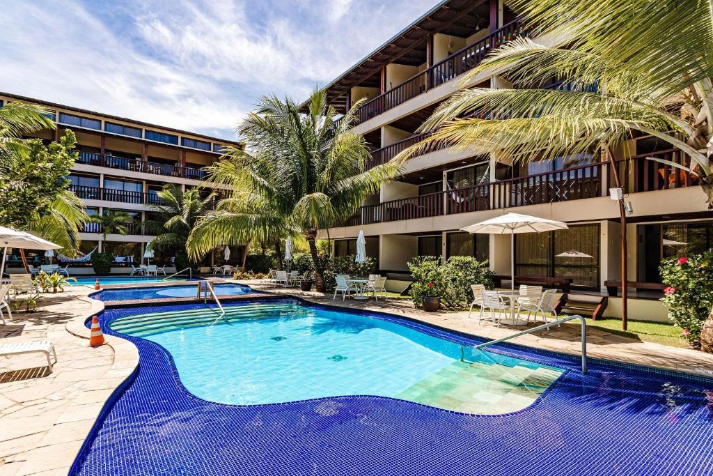 a large swimming pool in front of a building at Nannai Residence by AFT in Porto De Galinhas