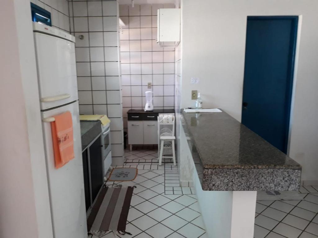 a kitchen with a sink and a counter top at Porto Canoa Apartamento in Aracati