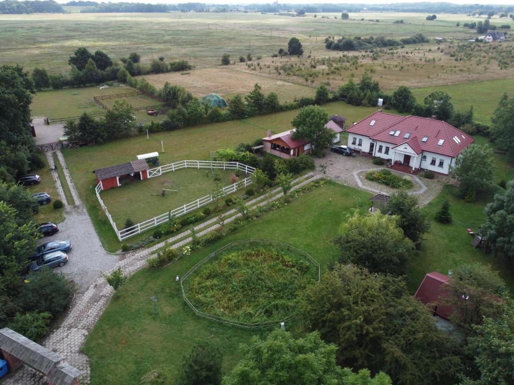 an aerial view of a house with a playground at Babie Lato in Włodarka