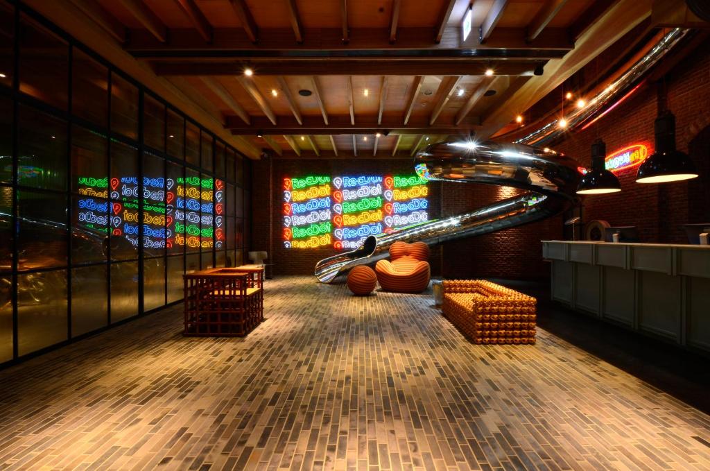 a room with a slide and stained glass windows at Reddot Hotel in Taichung