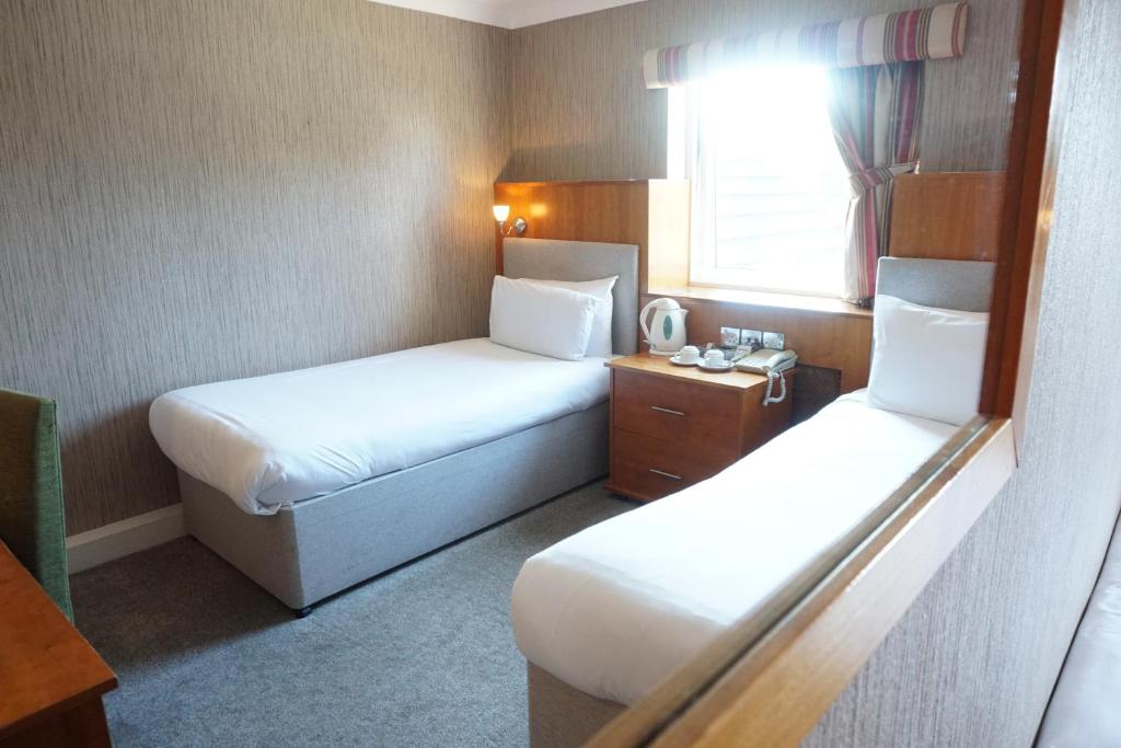 a hotel room with two beds and a window at The Park Hotel in Liverpool