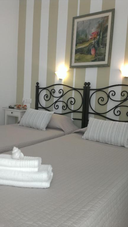 Postel nebo postele na pokoji v ubytování Hotel Cyclades
