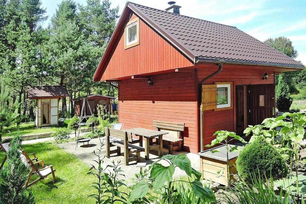 a small red building with a picnic table in front of it at Holiday resort, Wiselka in Wisełka