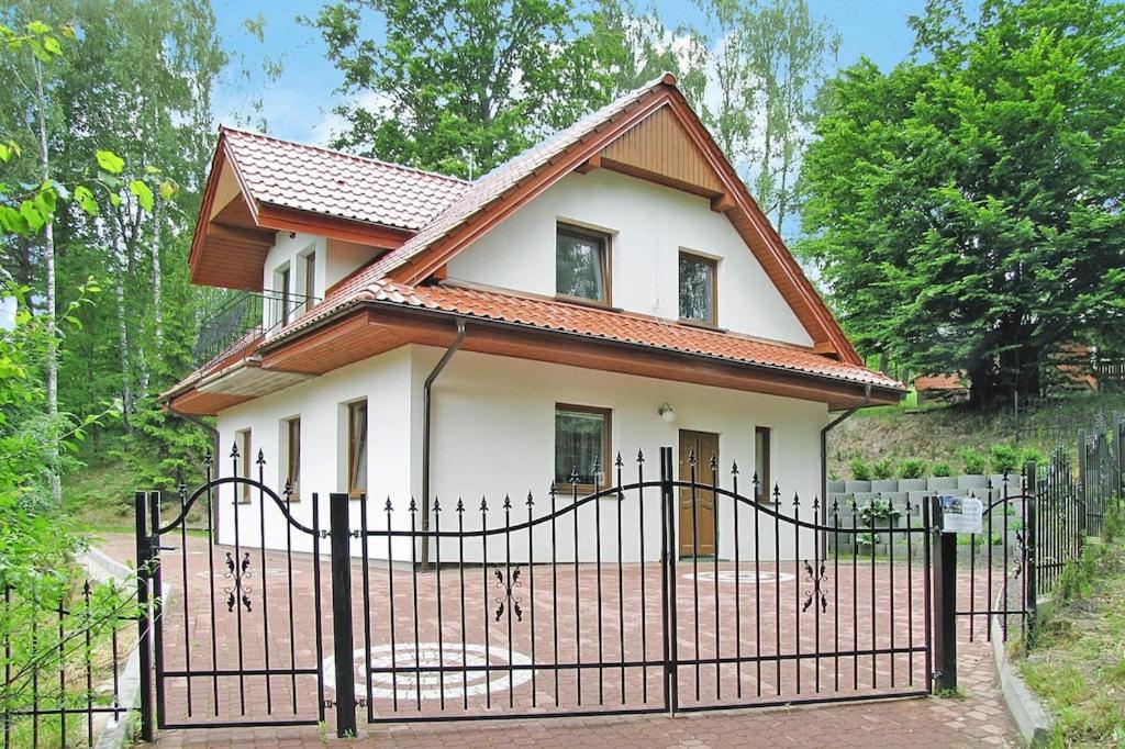 a small house with a gate in front of it at holiday home, Kretowiny in Kretowiny