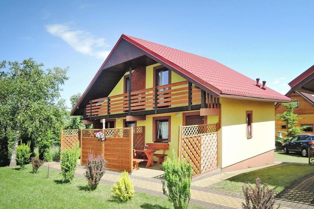 a small yellow house with a red roof at Holiday resort, Rewal in Rewal