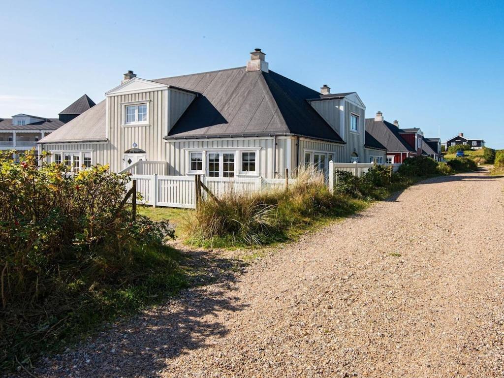 una casa al lado de un camino de tierra en 4 person holiday home in Ringk bing, en Ringkøbing