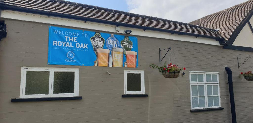 a sign for the royal oak on the side of a building at ROYAL OAK in Kinnersley