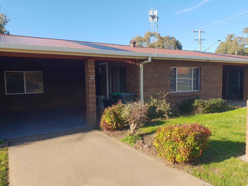 a brick house with a driveway in front of it at Inara Apartment Mudgee in Mudgee