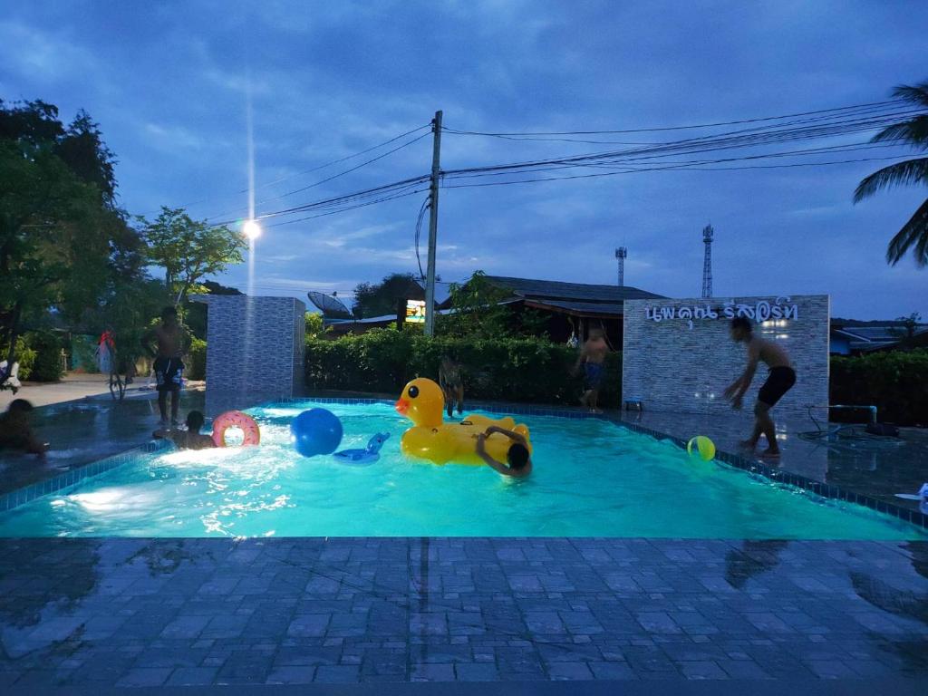 a swimming pool with a yellow rubber duck in the water at Noppakhun Resort in Ban Mai