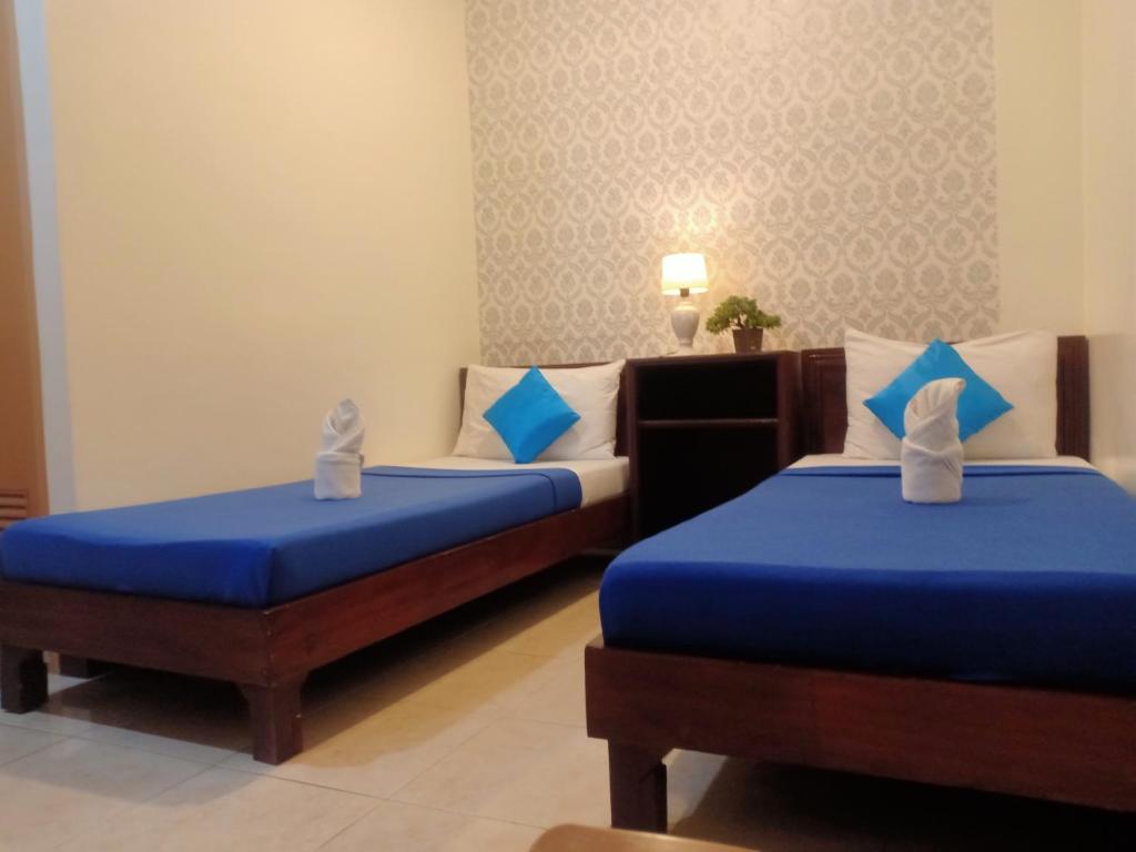 Postel nebo postele na pokoji v ubytování Davao Hub Bed and Breakfast