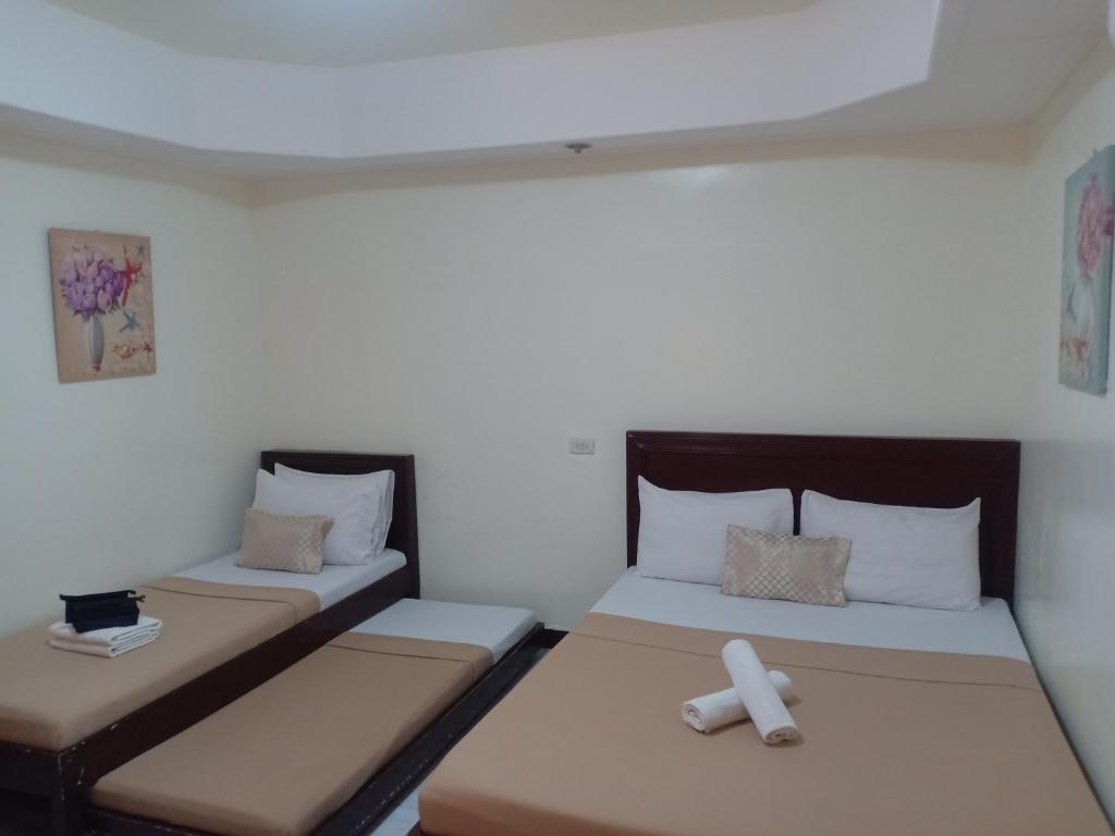 Postel nebo postele na pokoji v ubytování Davao Hub Bed and Breakfast