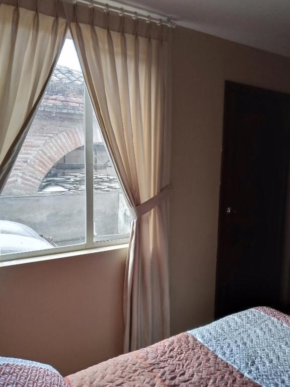 Postel nebo postele na pokoji v ubytování Hostal EL CALLEJÓN
