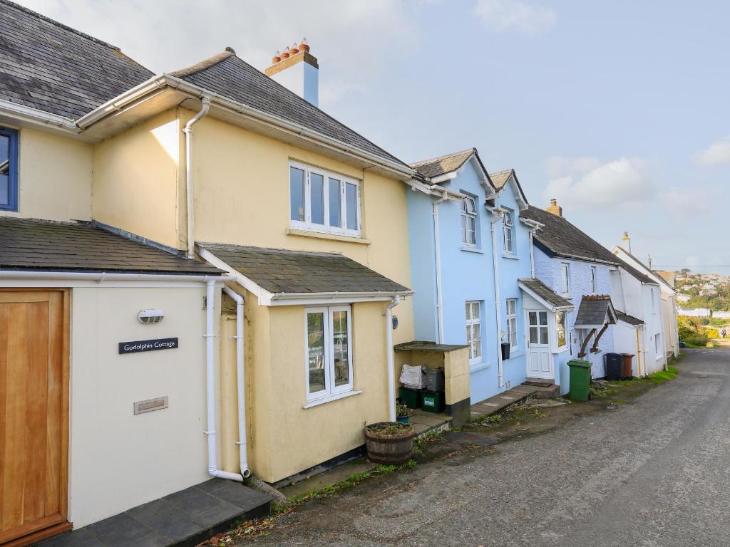 a row of colourful houses on a street at Bow Cottage in East Portlemouth