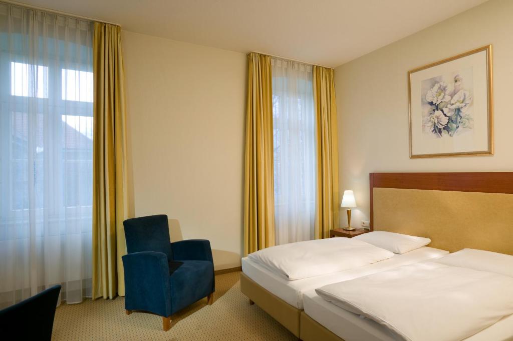Postel nebo postele na pokoji v ubytování Novotel Hildesheim