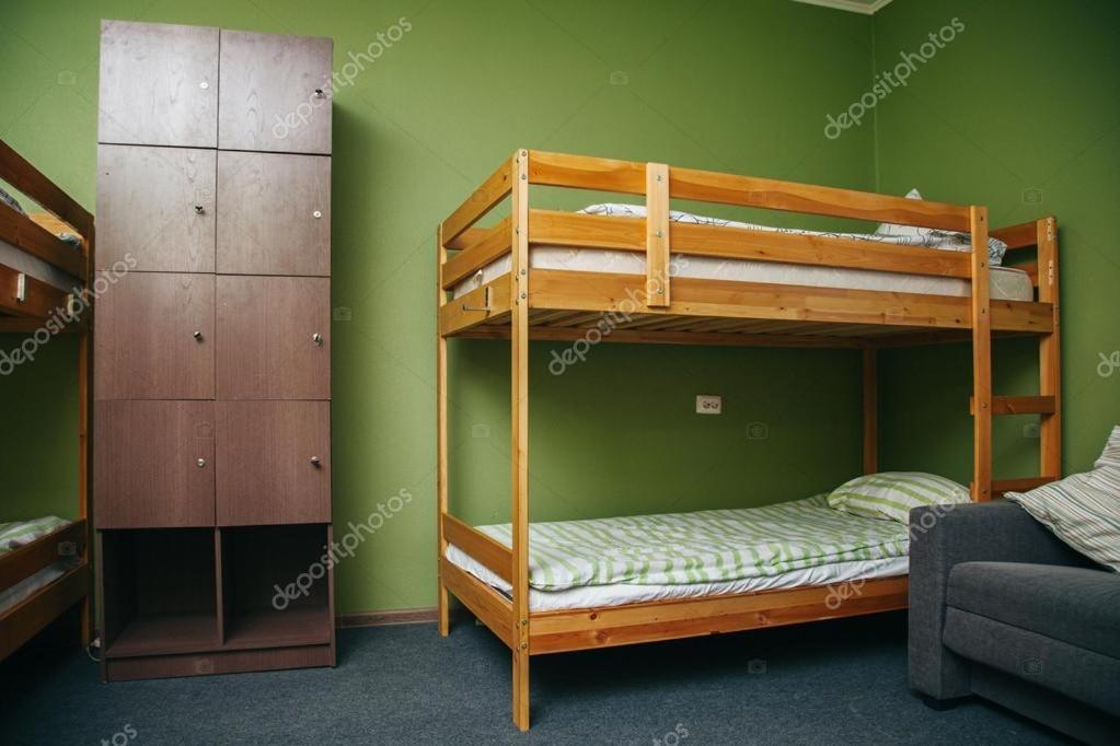 a bunk bed room with two bunk beds and a couch at just simple in Kalamata