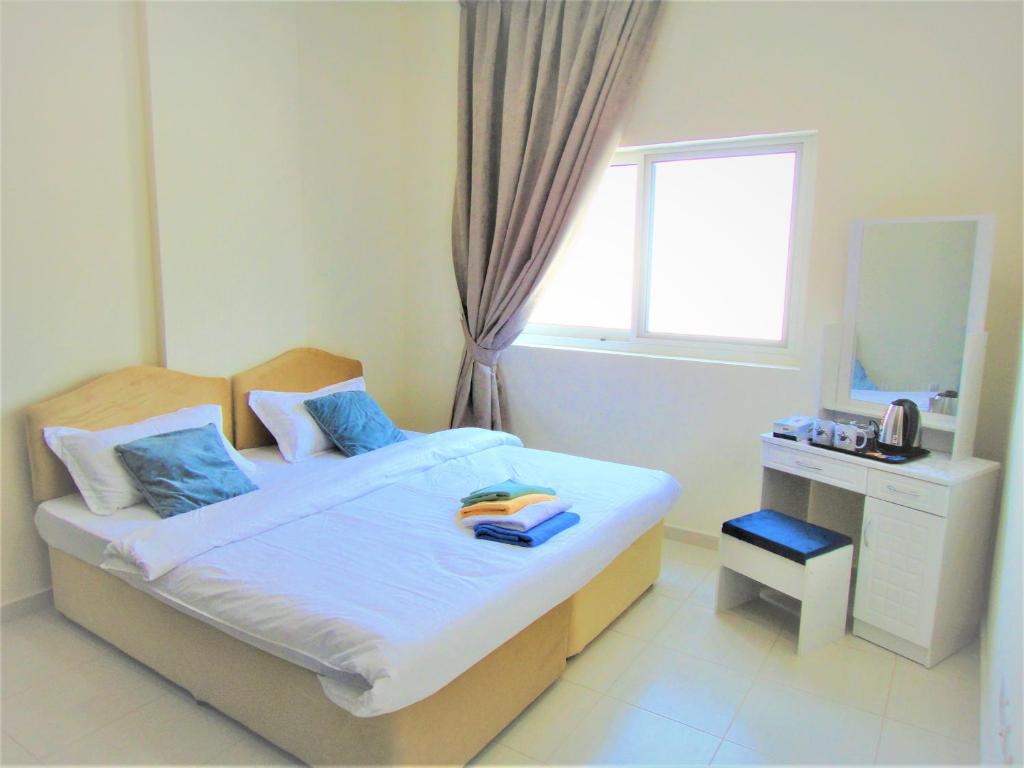 Postel nebo postele na pokoji v ubytování Abu Hail Star Residence - Home Stay