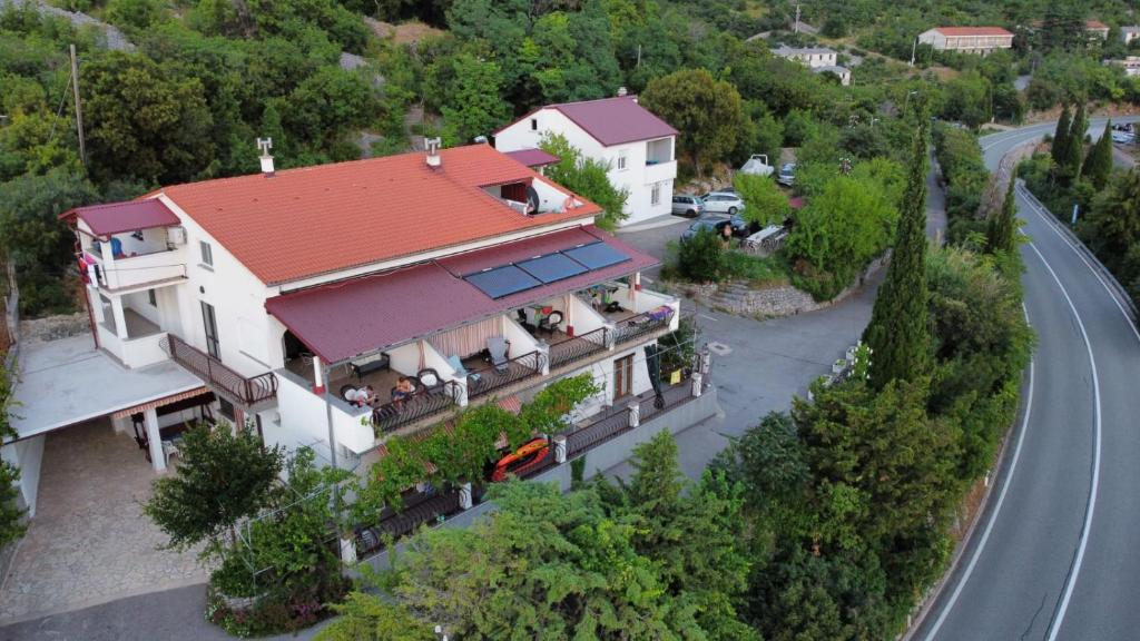 an aerial view of a house with a road at Delfin Apartments in Sveti Juraj