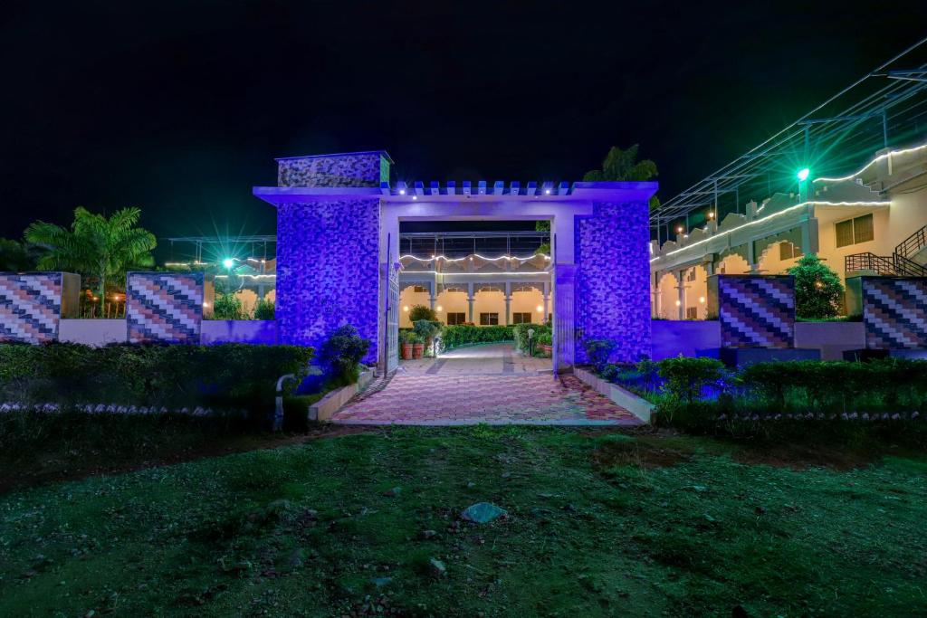 a building with purple lights on it at night at Brindavan Garden Resort & Spa in Mysore