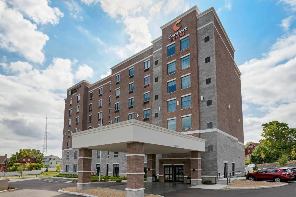 a large building with a clock on the front of it at MainStay Suites Cincinnati University - Uptown in Cincinnati