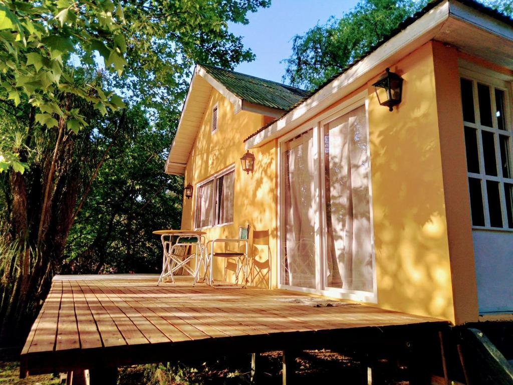 a house with a wooden deck with a table on it at Delta Tigre in Tigre