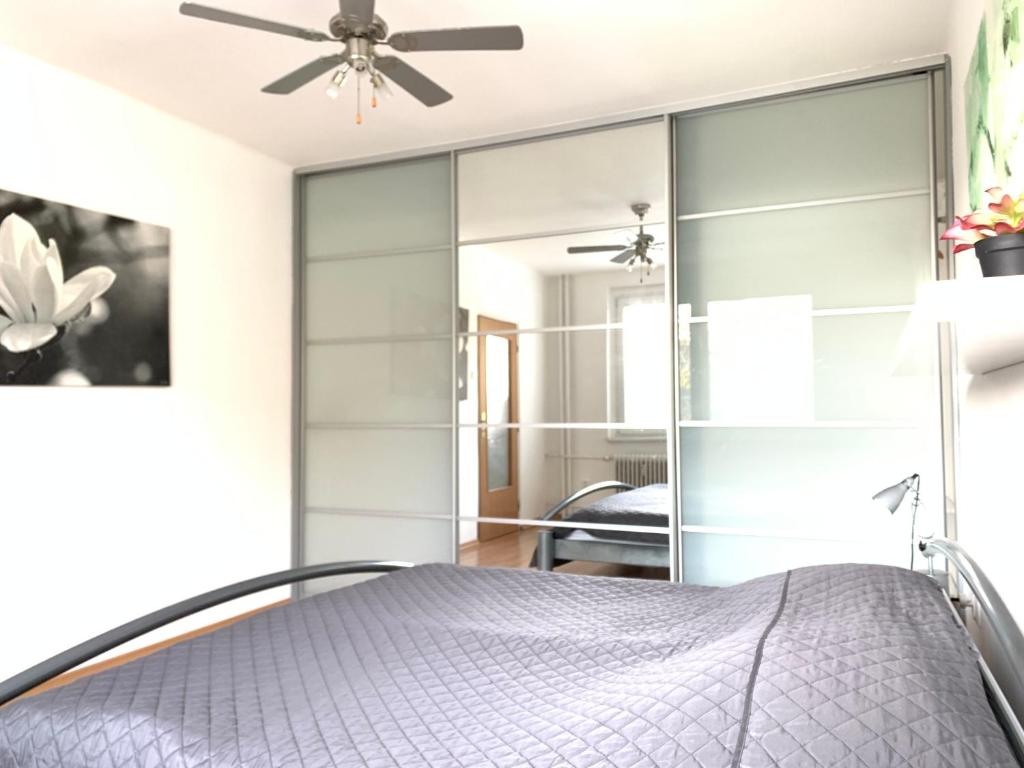 a bedroom with sliding glass doors at Apartament T&Hos in Trnava