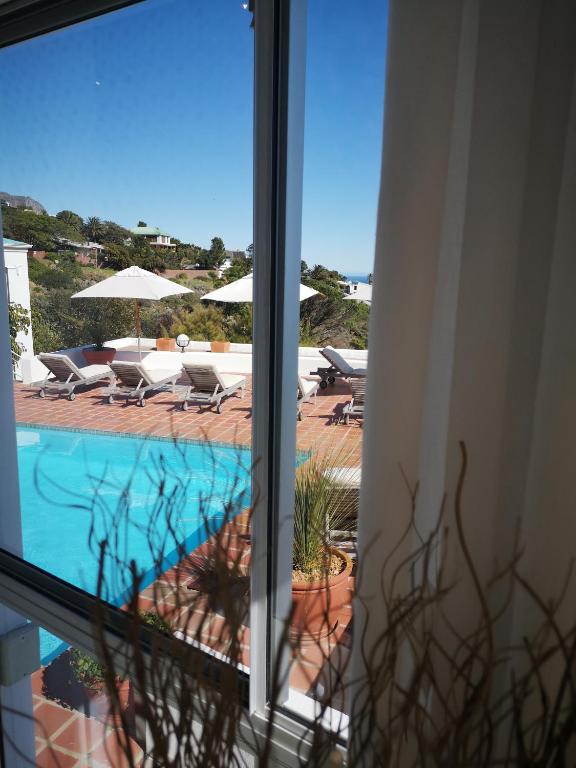 a view of a swimming pool from a window at Diamond House Guesthouse in Cape Town