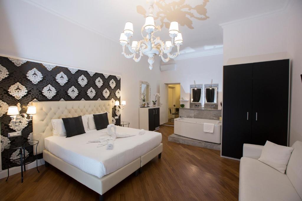 a bedroom with a large bed and a bath room at NAVONA VITA SUITES in Rome