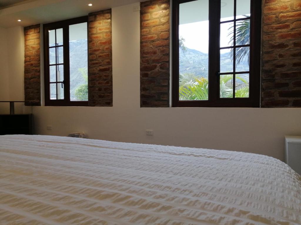 Postel nebo postele na pokoji v ubytování Hostal & Spa Casa Real
