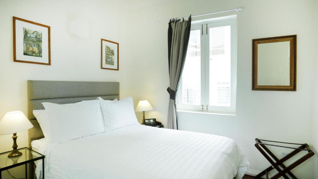 Postel nebo postele na pokoji v ubytování La Rabida Hotel Boutique