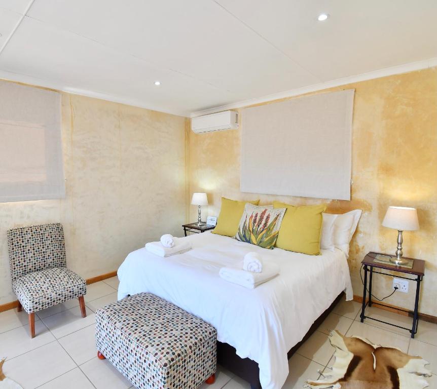 a hotel room with a bed and a desk at Le Petit Karoo Ranch in Oudtshoorn