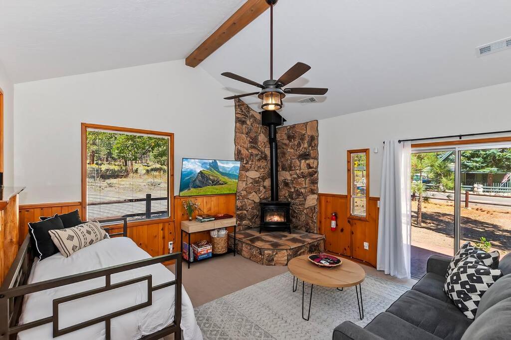 a living room with a couch and a fireplace at DoorMat Vacation Rentals - Brother Bear Cabin with free WIFI! in Big Bear City