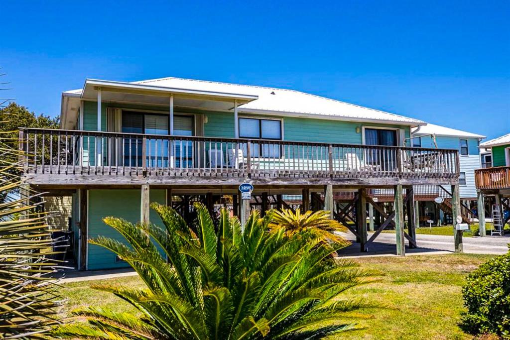 a house with a large deck on the side of it at The Dugout by Meyer Vacation Rentals in Gulf Shores