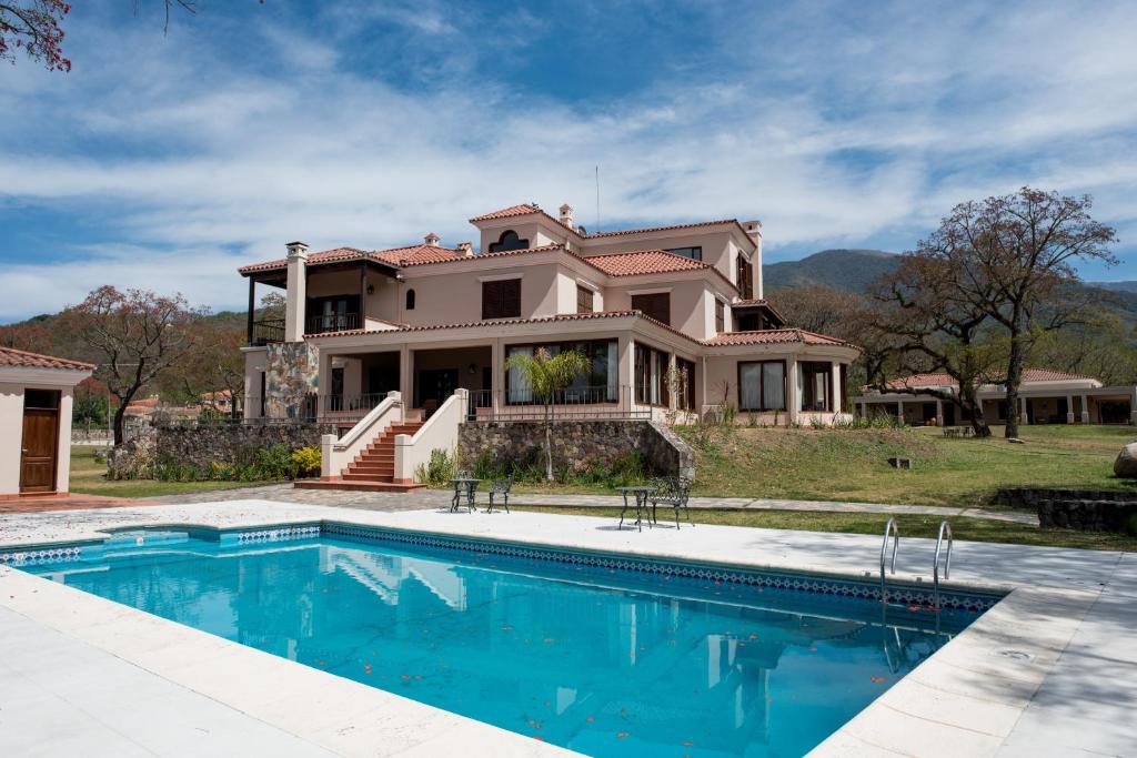 a large house with a swimming pool in front of it at Rincon del Cerro in San Lorenzo