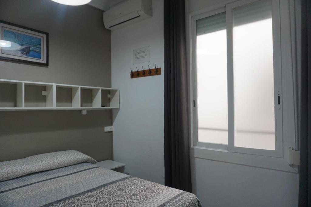 Postel nebo postele na pokoji v ubytování Pensión Casa Blanca