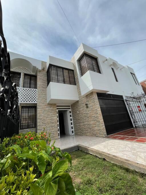 a brick house with a gate and a garage at Casa Marina Espectacular Casa Completa in Valledupar